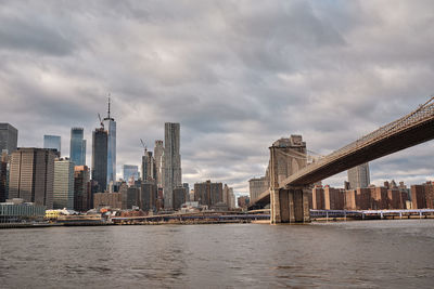 Modern buildings in city against cloudy sky