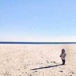 Full length of woman standing on beach