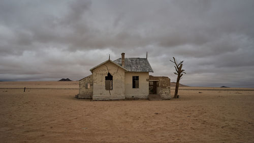 Built structure on beach against sky