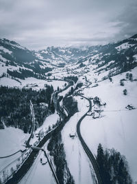 Aerial view of snowcapped mountain against sky
