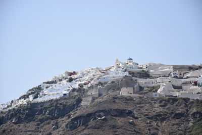 Low angle view of buildings against clear blue sky