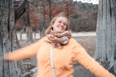 Portrait of smiling woman standing outdoors