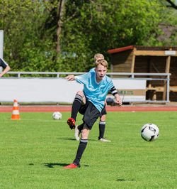 Full length of man playing soccer ball on field