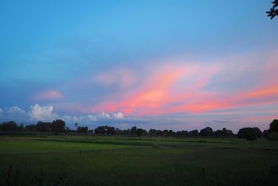 Scenic view of field against sky during sunset