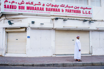 Rear view of man standing by building