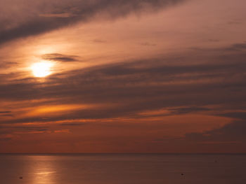 Scenic view of sea against orange sky