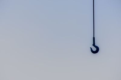 Low angle view of electric lamp against clear sky