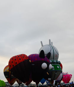 Low angle view of balloons against sky