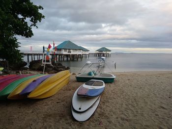 Surfboards on beach against sky