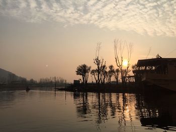 Scenic view of lake against sky at sunset