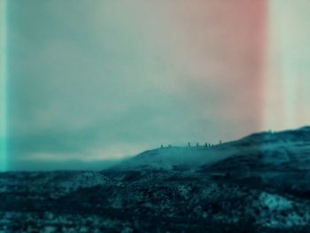 Scenic view of landscape against sky during winter