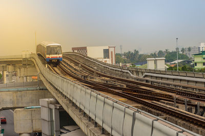 High angle view of train at railroad station against sky