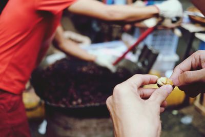 Cropped hands holding street food