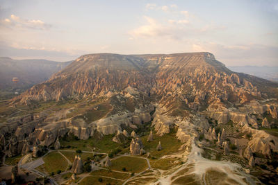 Scenic view of mountain range against cloudy sky