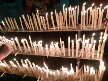 Low angle view of illuminated candles in temple