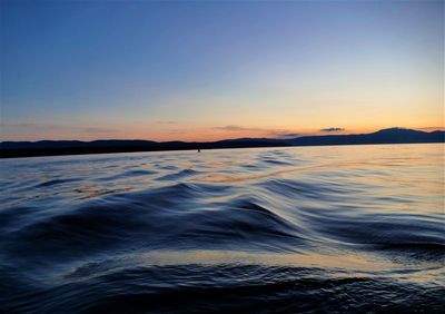 Scenic view of sea against clear sky during sunset
