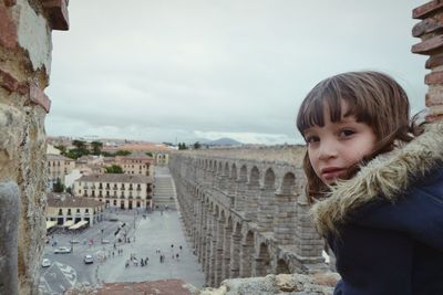 Portrait of girl against old ruins in city