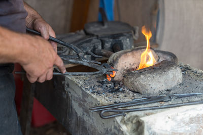 Midsection of man preparing food on stove