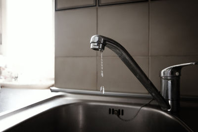 Close-up of faucet in bathroom