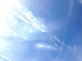 Low angle view of vapor trails in sky