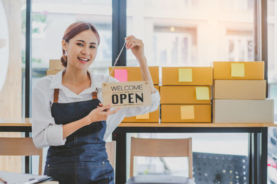 Portrait of smiling young businesswoman using mobile phone