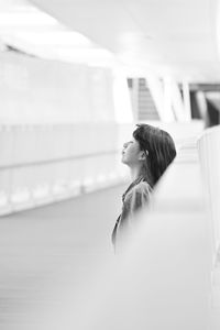 Side view of woman standing at airport