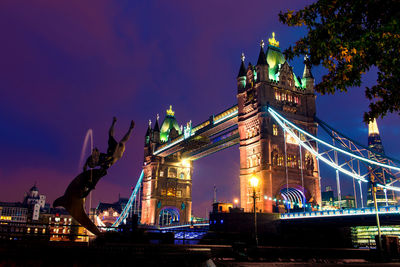 View of illuminated tower bridge against sky