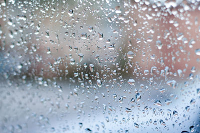 Full frame shot of wet glass window during rainy season