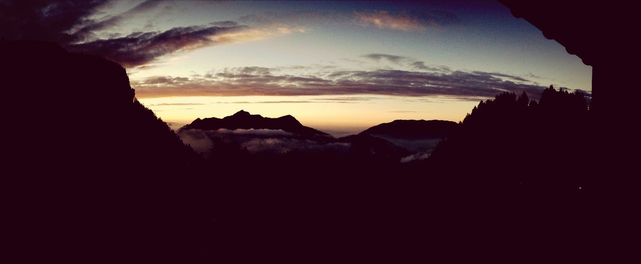 silhouette, sunset, scenics, tranquil scene, sky, beauty in nature, tranquility, mountain, nature, dark, idyllic, dusk, rock formation, outline, orange color, cloud - sky, majestic, mountain range, landscape, rock - object