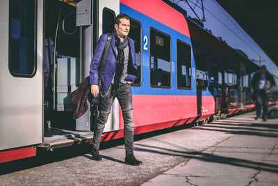 Full length of man walking on railroad station platform