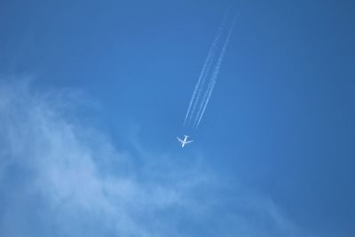 Low angle view of airplane flying in sky