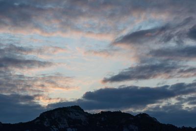 Low angle view of silhouette mountains against sky at sunset