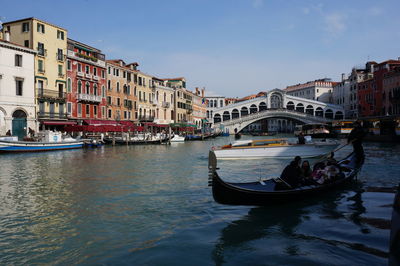 Boats in canal along buildings