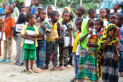 Group of people at market stall in city