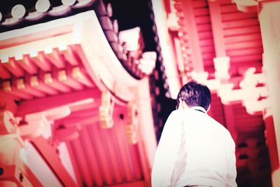 Rear view of man walking in temple