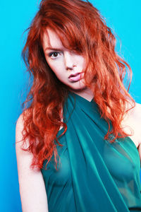 Portrait of a beautiful young woman over blue background