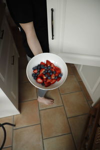 High angle view of man holding bowl at home