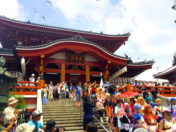 People at temple against sky