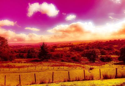 Scenic view of field against cloudy sky