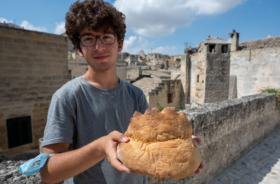 Portrait of young man holding food