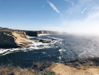 High angle view of sea by cliff against sky