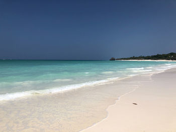 Scenic view of beach against clear sky