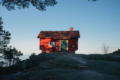 Red cabin against clear blue sky