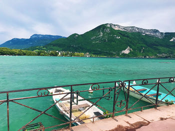 Scenic view of sea and mountains against sky
