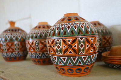 Close-up of multi colored pencils on table pottery teapot clay ornament handmade