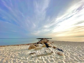 Scenic view of beach against sky during sunset