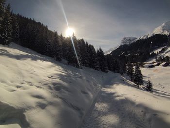 Scenic view of snow covered mountains against sky