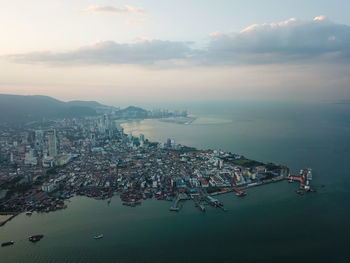 High angle view of buildings by sea against sky