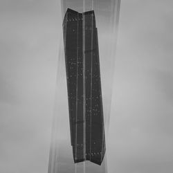 Close-up of wet glass against sky