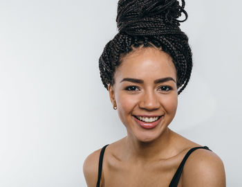 Portrait of happy woman against white background